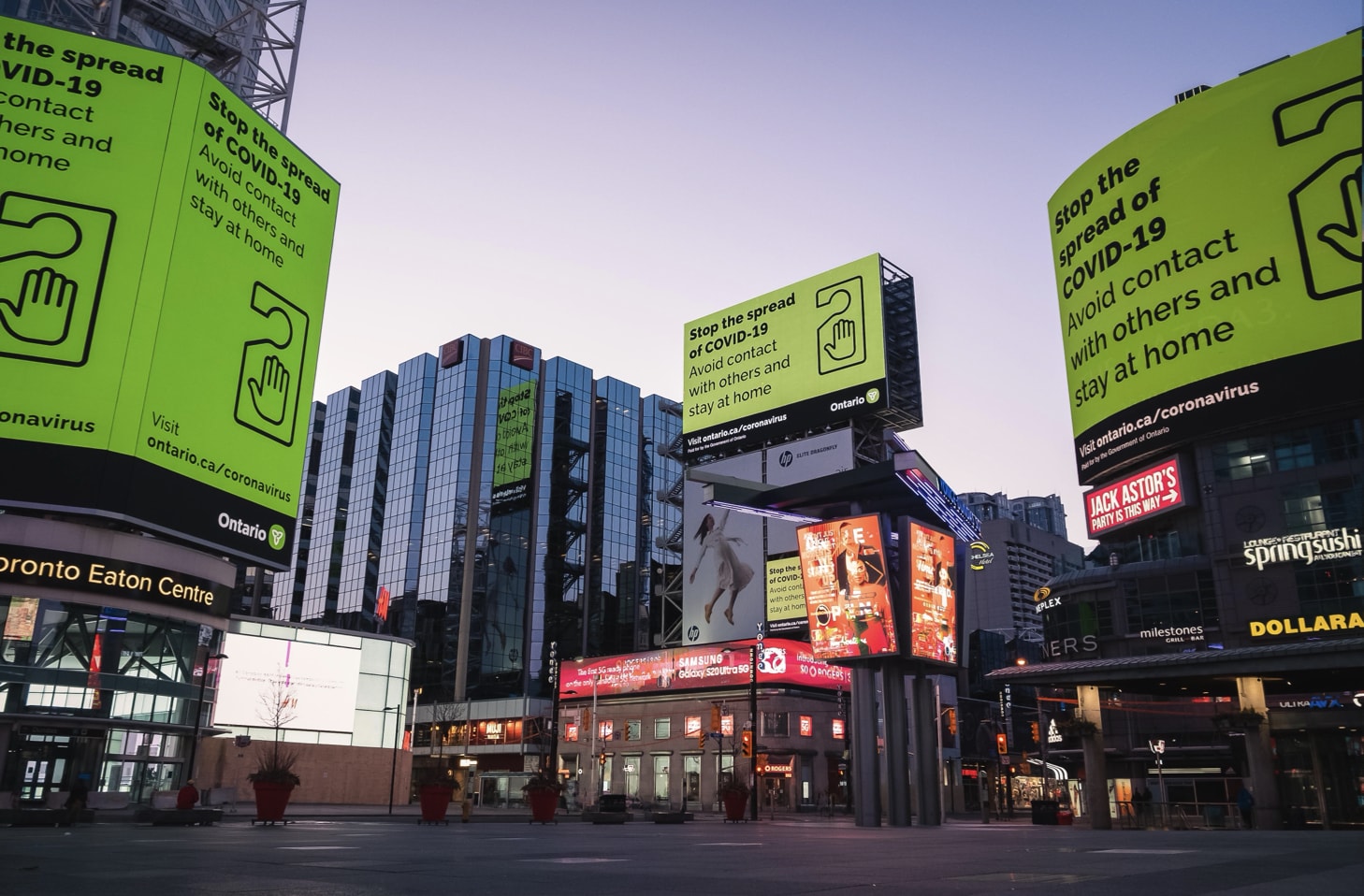 Yonge and Dundas Square billboard takeover with COVID-19 health messaging.